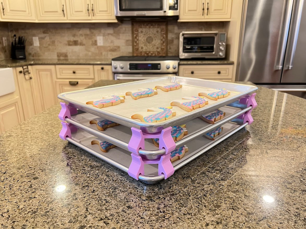 3D printed baking sheet organizers at an angle in lavender, neatly holding and organizing multiple cookie sheets to save counter space in the kitchen.