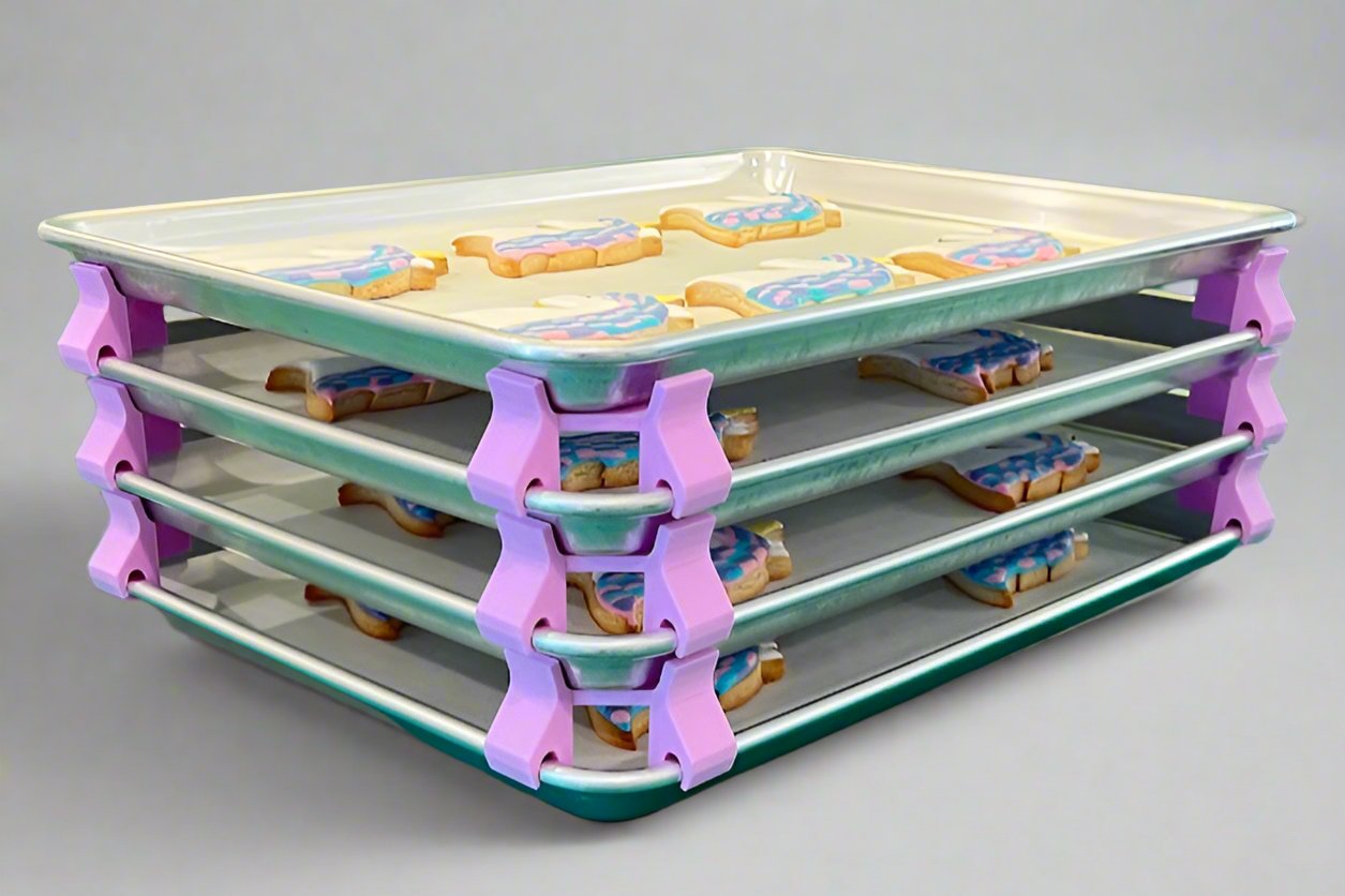 3D printed baking sheet organizers at an angle in lavender, neatly holding and organizing multiple cookie sheets to save counter space in the kitchen.