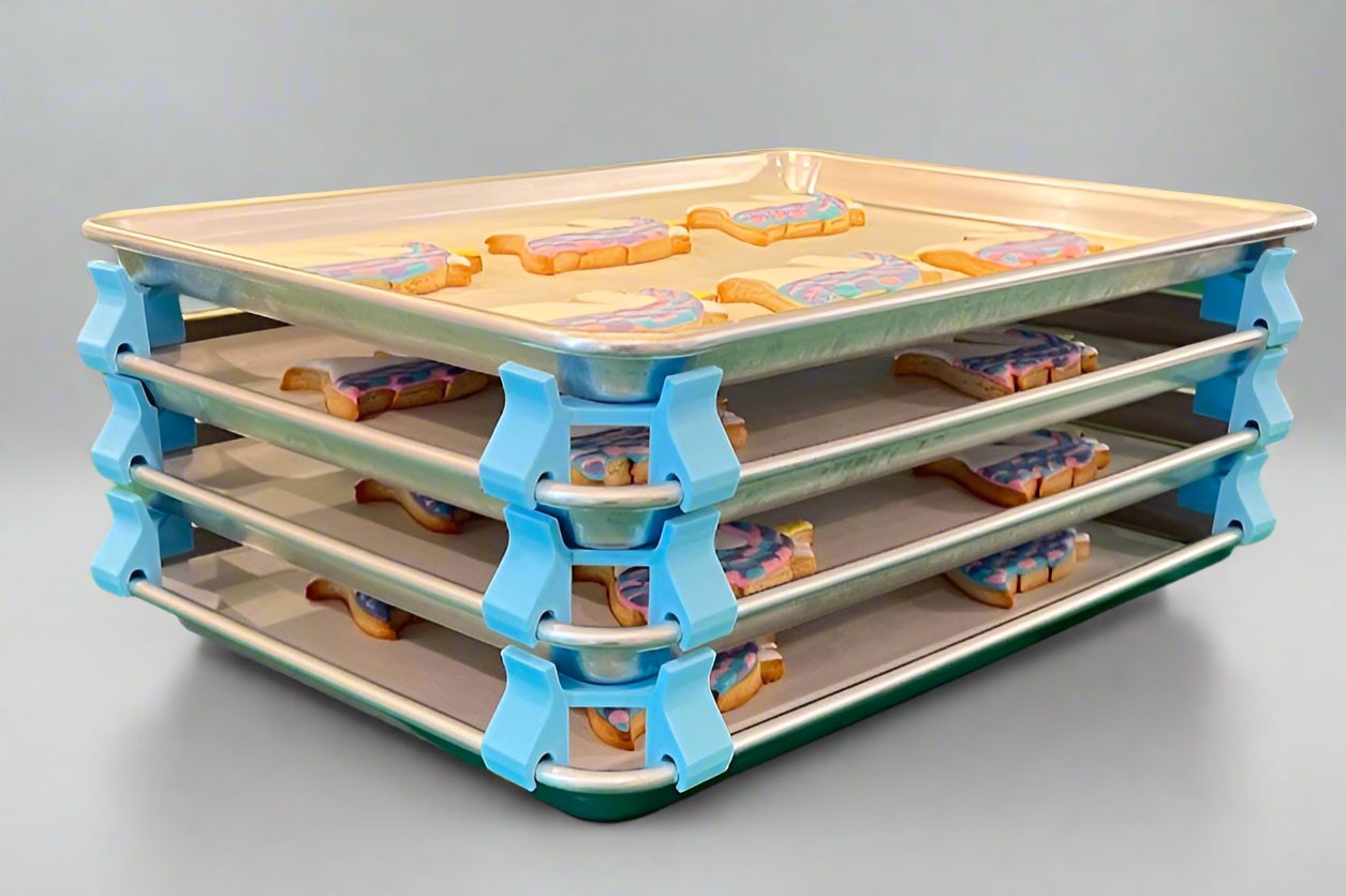 3D printed baking sheet organizers at an angle in light blue, neatly holding and organizing multiple cookie sheets to save counter space in the kitchen.
